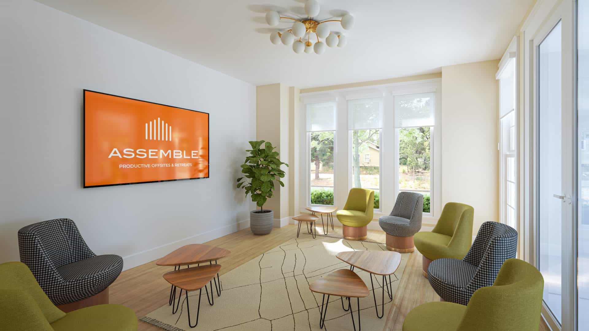 Assemble Boise meeting room with modern furniture and a large screen for productive offsites and retreats.