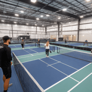 Indoor pickleball courts at Two Assemble Boise. Players enjoying a game of pickleball.