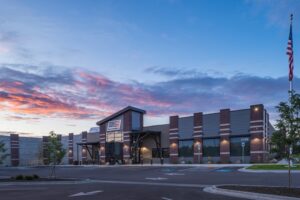 Shooting Range in Boise, Idaho. Exterior view of the Assemble shooting range facility with American flag and parking lot.