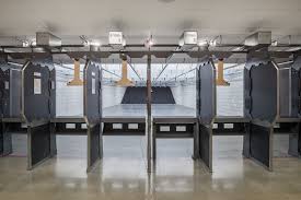 Indoor shooting range at Three Assemble Boise, with target stands and safety barriers. Shooting sports facility.