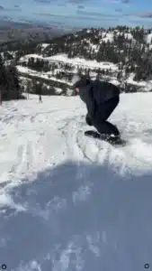 Snowboarder carving down snowy mountain in Boise, Idaho. Winter snowsports adventure in the mountains.