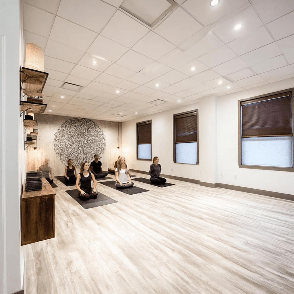 Yoga class in Boise studio. People meditating in lotus pose. Calm exercise with wellness focus. Boise yoga center.