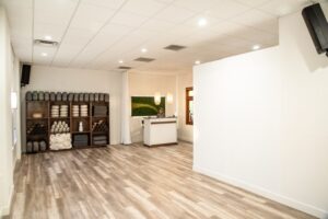 Bright Boise yoga studio with mats, towels, wood floors and a reception desk. Clean, modern space for yoga classes.