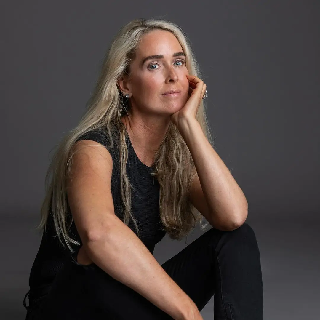 Yoga Class instructor in Boise, woman with long blonde hair, wearing black athletic wear, looking at the camera.
