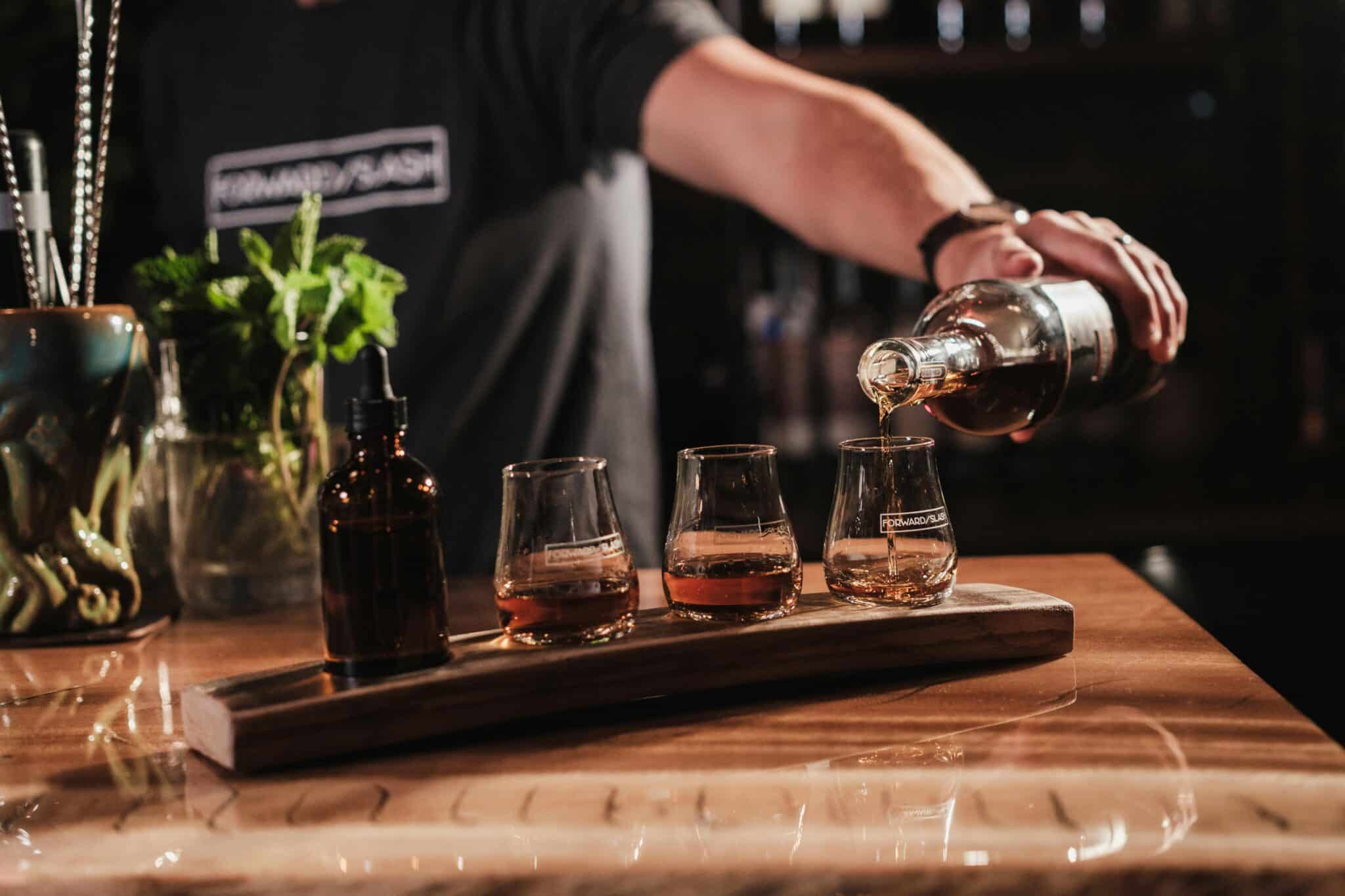 Bartender serving drinks in glasses at a downtown Boise bar