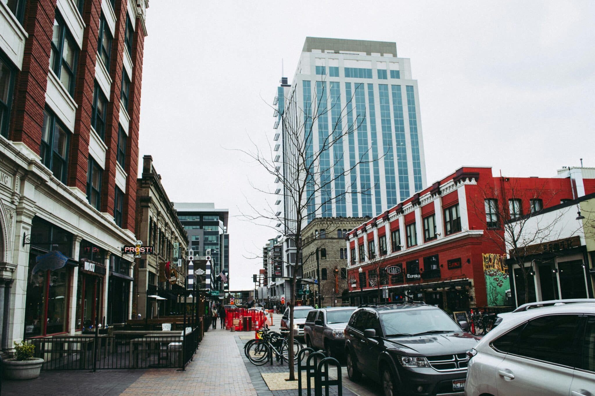 Downtown Boise street with brick buildings and a high-rise, showing where to stay in Boise, ID.