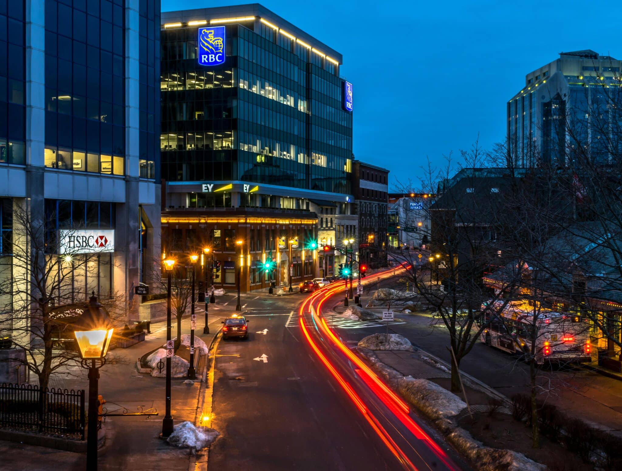 Nighttime downtown Boise street with city lights and traffic trails, showing where to stay in Boise, ID.
